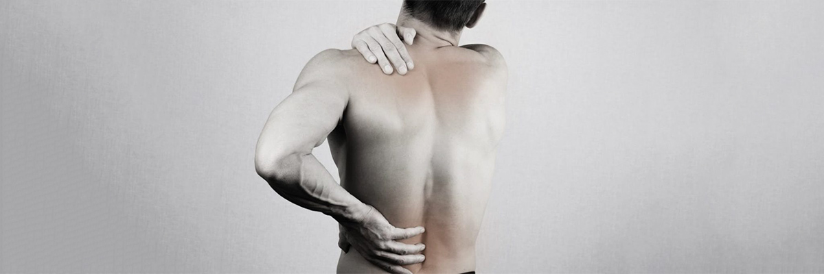 Man Standing Holding Hand on the Back because of Back Pain