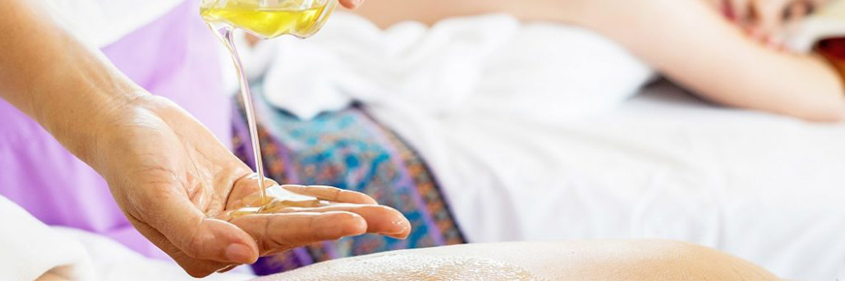Woman pouring massage oil on her hand before Massage