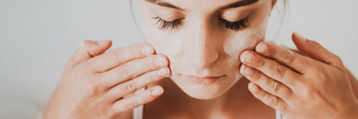 Beatiful Woman Putting Cream on her Face